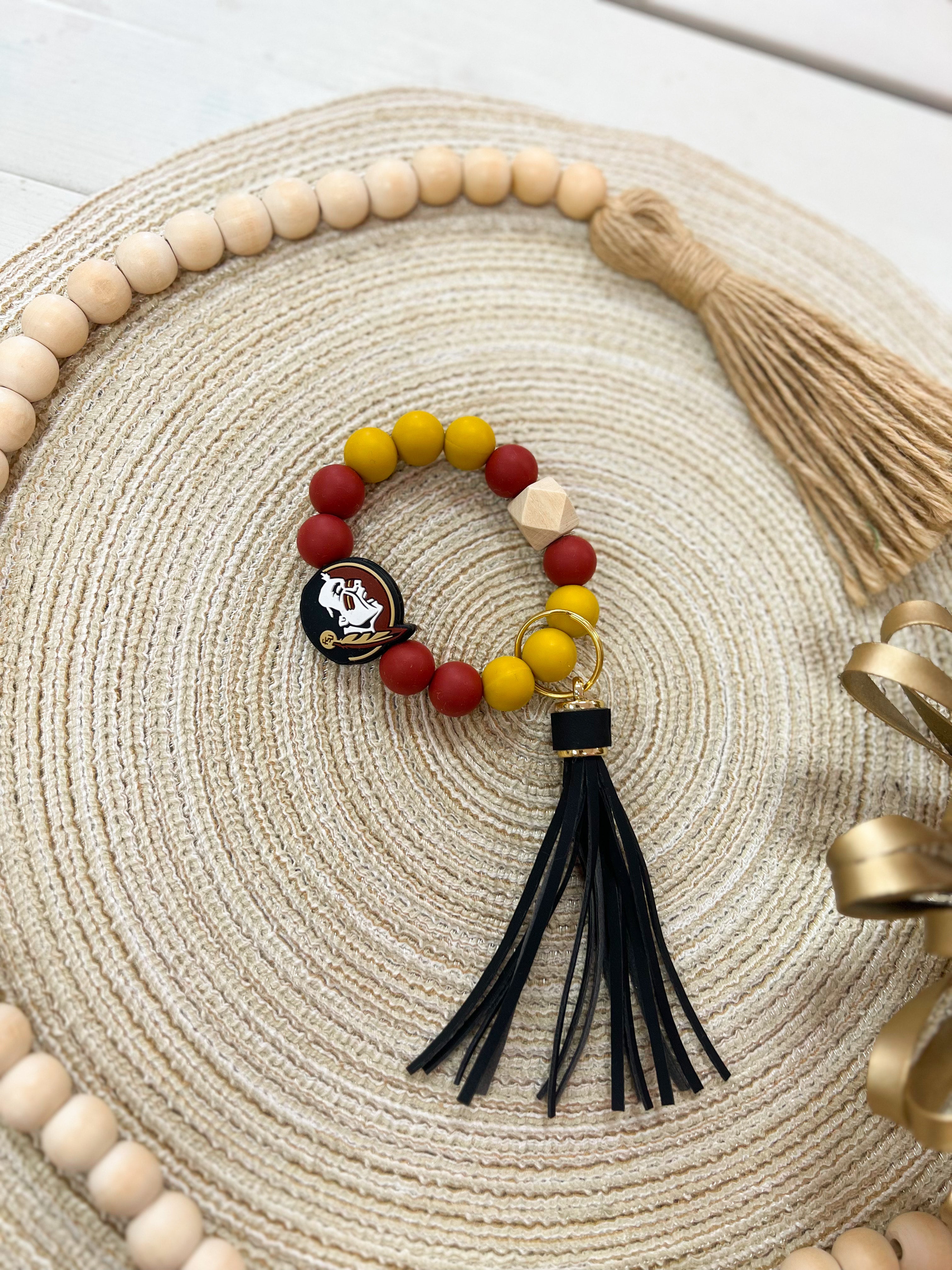 garnet and gold silicone beaded FSU keychain with black tassel and wooden bead