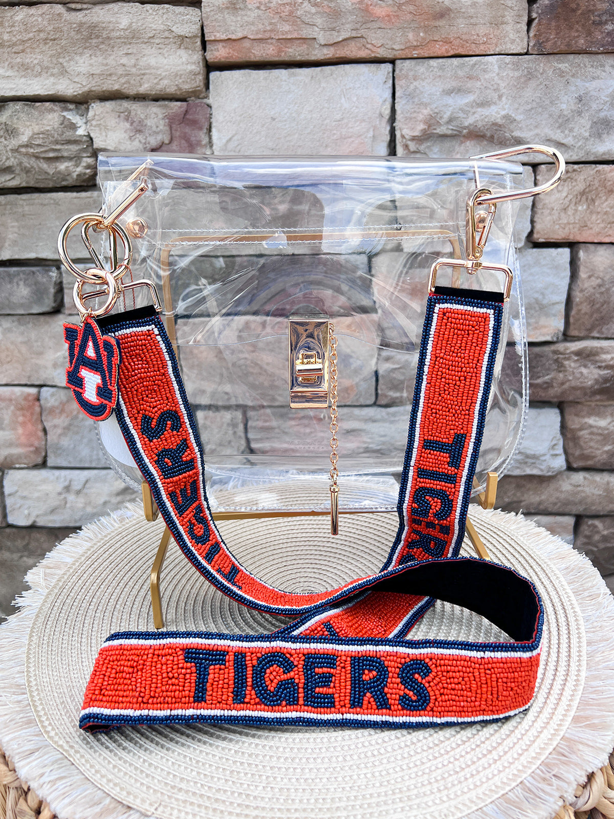 Orange hand-beaded handbag strap with navy "TIGERS" lettering and gold-tone clasp hardware.