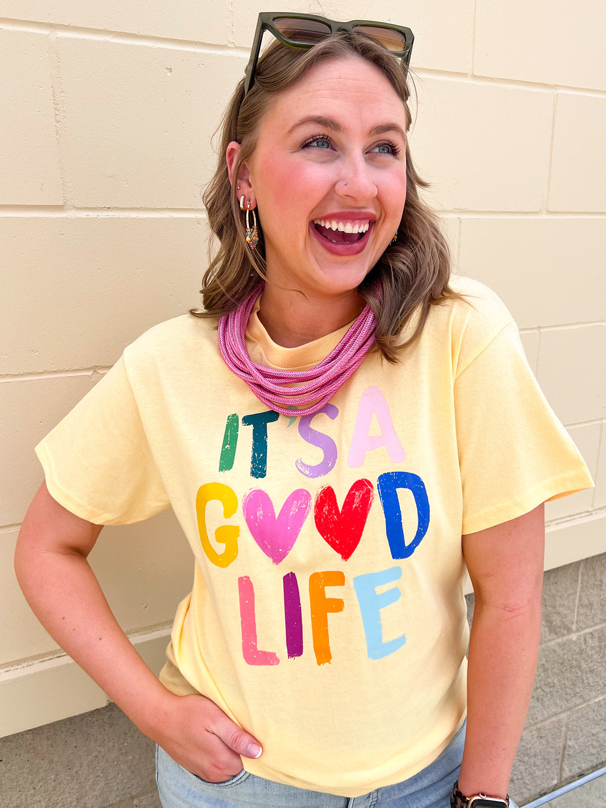 Pastel yellow graphic tee with colorful lettering and heart details
