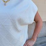 Ivory short-sleeve knit top with subtle tonal criss-cross texture