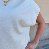 Ivory short-sleeve knit top with subtle tonal criss-cross texture