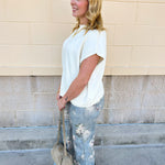 Ivory short-sleeve knit top with subtle tonal criss-cross texture