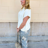 Ivory short-sleeve knit top with subtle tonal criss-cross texture