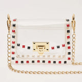 The Jackie Clear Stadium Bag with black and red studs and a gold chain strap