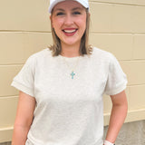 Taupe short sleeve knit top with ribbed collar and cuffed sleeves, styled casually with matching knit pants.