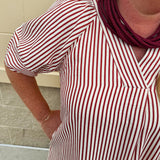 Garnet and cream striped midi dress with lantern sleeves, V-neckline, side slits, and horizontal stripe contrast at hem and sleeve cuffs