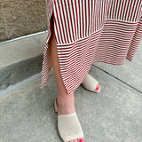 Garnet and cream striped midi dress with lantern sleeves, V-neckline, side slits, and horizontal stripe contrast at hem and sleeve cuffs