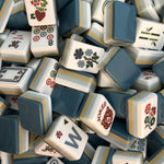 Laken mahjong tile set featuring misty blue, soft sand, white, and deep blue acrylic tiles