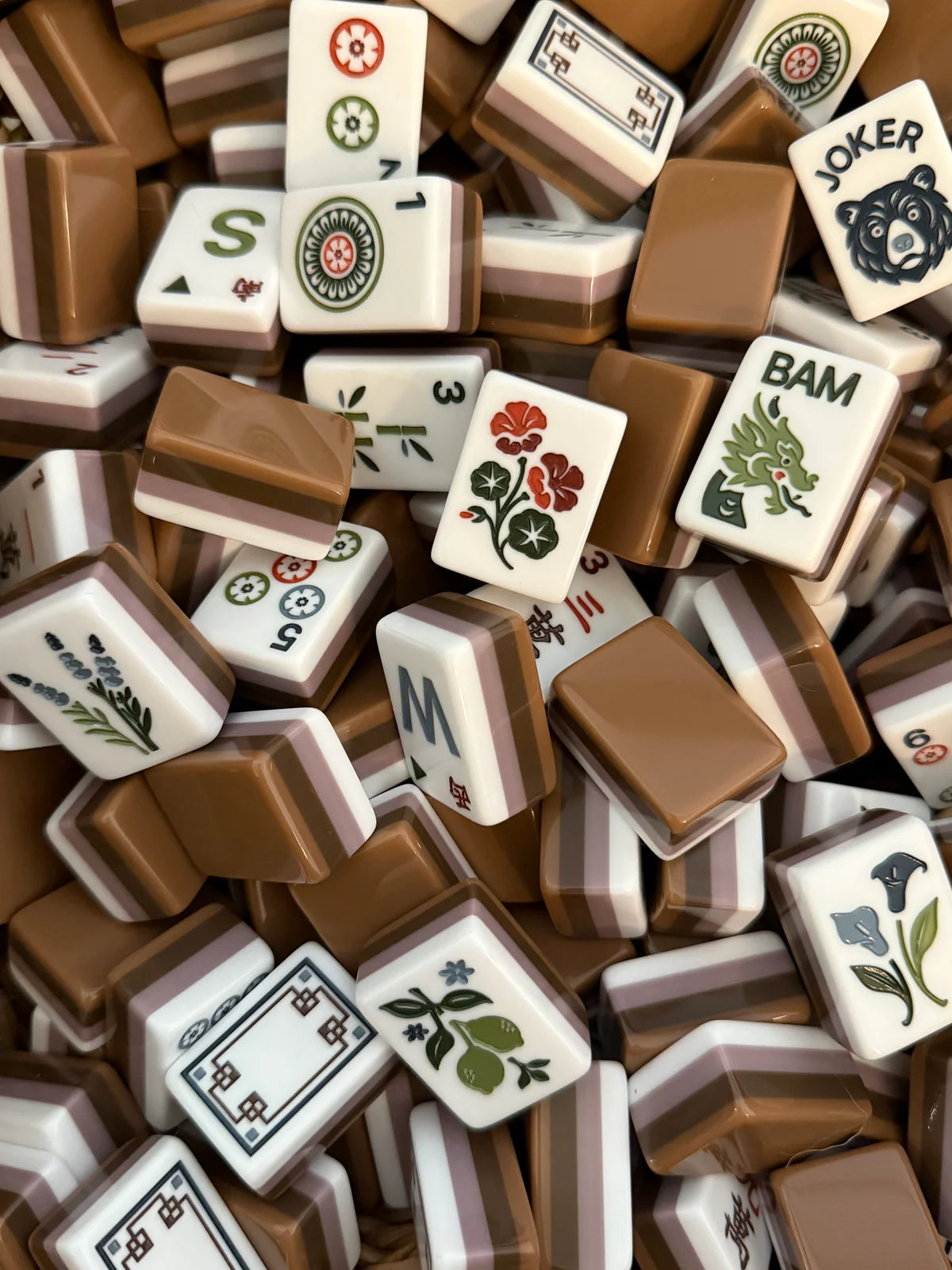 Mabel mahjong tile set featuring soft mauve, warm cocoa, and rosewood-toned acrylic tiles