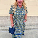 Lainey Midi Dress Orchid Damask Olive with dark green background, blue floral designs, white leaf accents, short sleeves, and ruffled collar