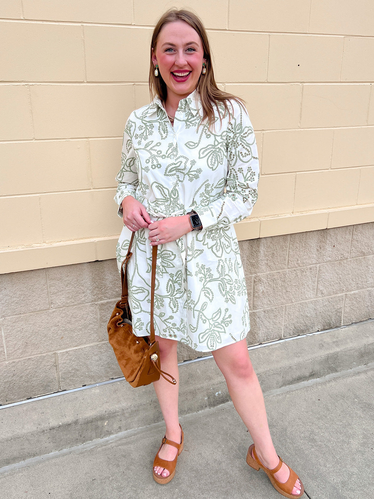 White floral mini dress with green print, classic collar, button front, and removable belt
