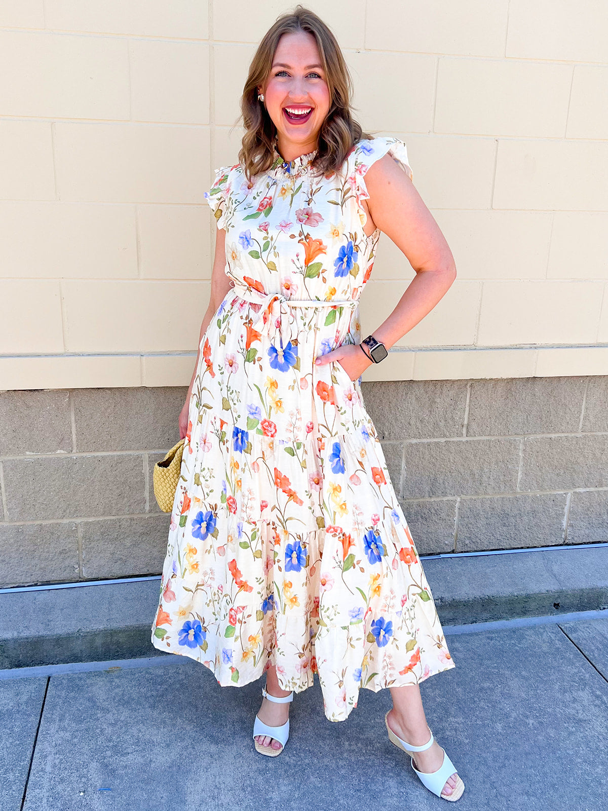 white maxi dress with blue and orange floral detail and tie-waist