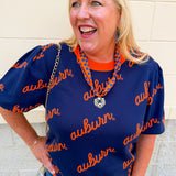 Women's navy puff sleeve knit sweater featuring scattered cursive auburn lettering and a classic crew neckline.