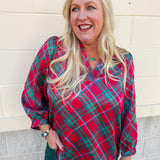 Pink, red, and green plaid top with ruffle neckline and three-quarter puff sleeves with cuffs.