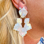 Long iridescent statement earrings with blue, mint, pink, and purple tones, inspired by seashells and crafted from eco-friendly materials