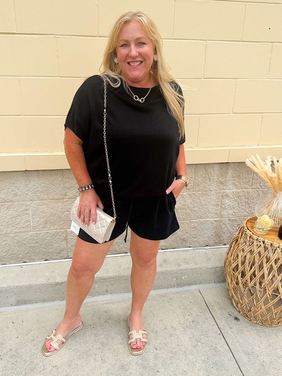 Solid black lounge set with U-neck dolman sleeve top and drawstring shorts, styled for cozy-casual wear.