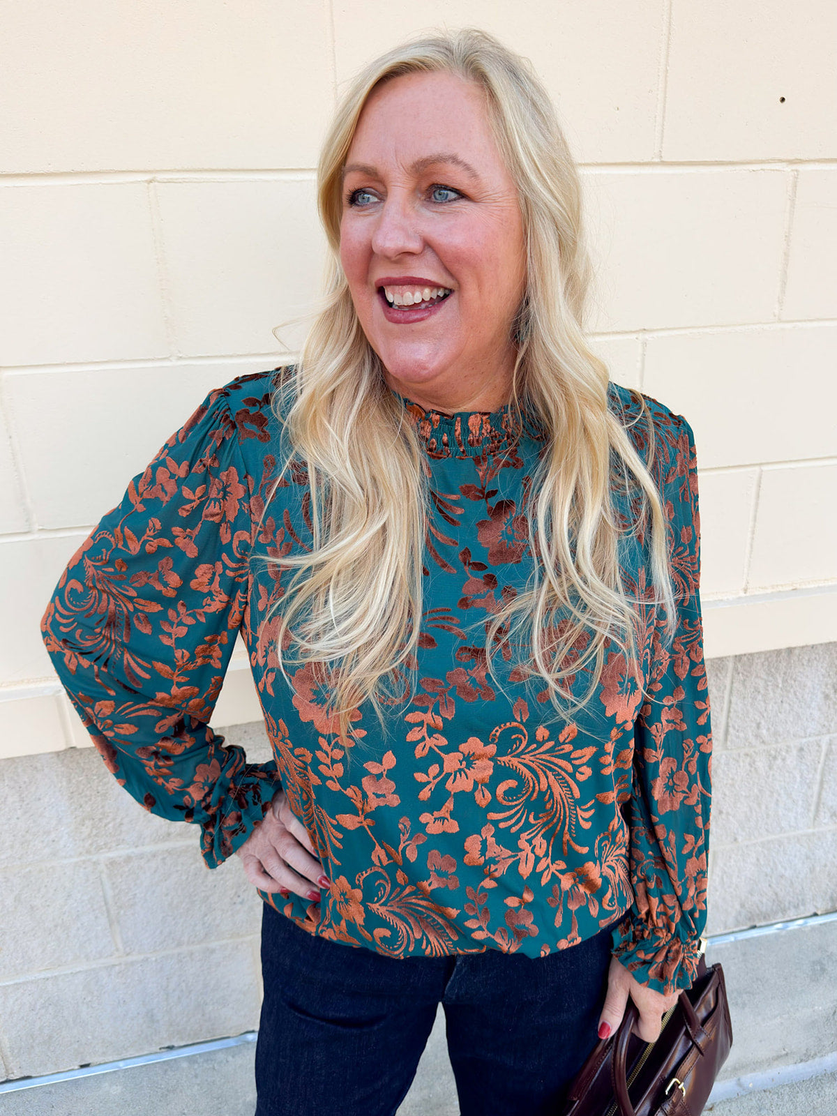 Dark teal velvet jacquard top with gold floral print, ruffled neckline, and long ruffled cuffs.