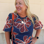 Navy short sleeve top with embroidered floral-inspired pattern