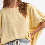 Golden yellow short sleeve blouse with a relaxed fit and dolman sleeves, styled for casual or dressy occasions.