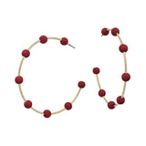 Gold hoop earrings with maroon-coated metal bead accents, offering a bold yet elegant pop of color.