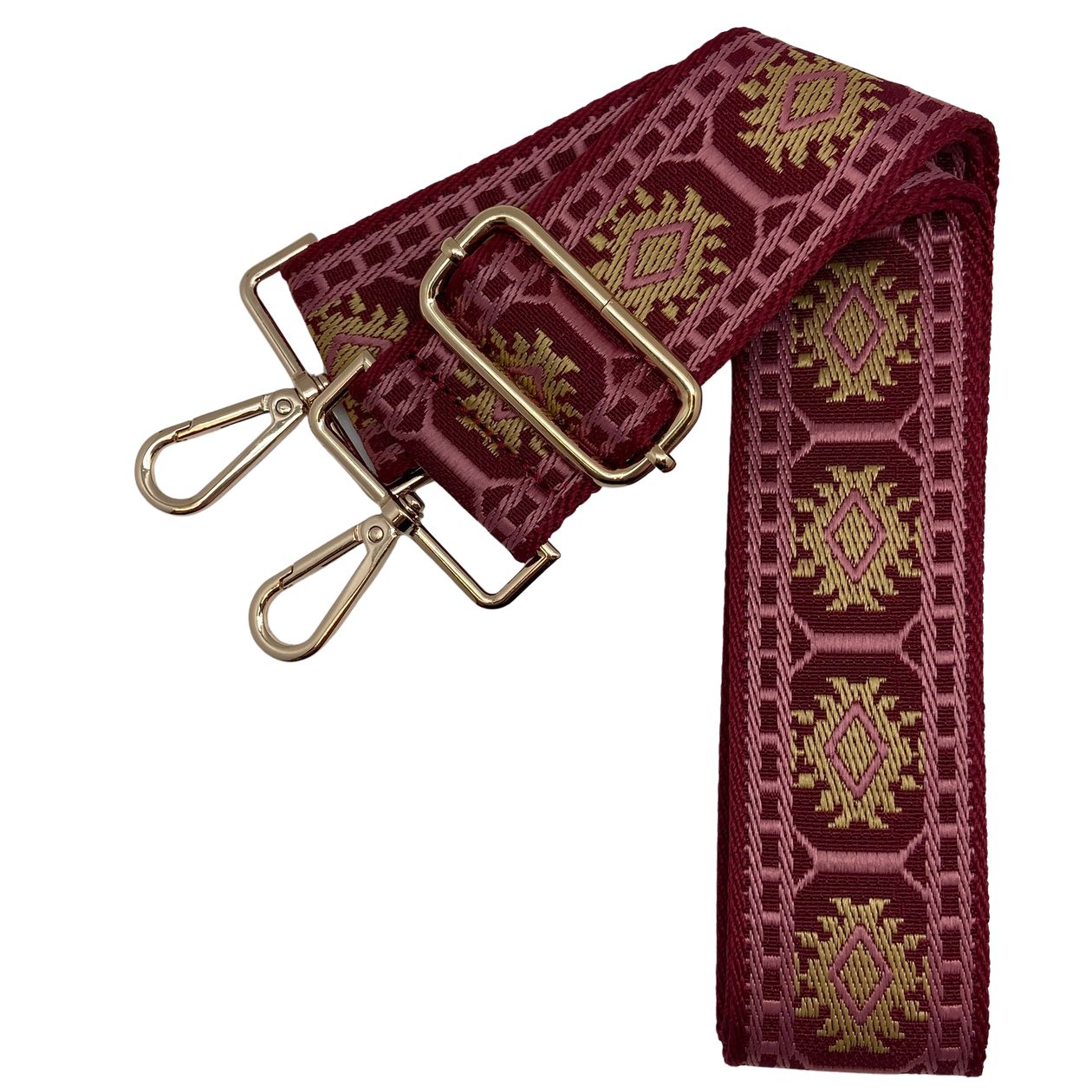 Adjustable garnet bag strap with pink and gold pattern, gold hardware shown on a gameday clear bag