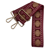 Adjustable garnet bag strap with pink and gold pattern, gold hardware shown on a gameday clear bag
