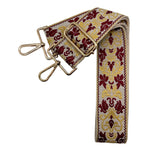 Ivory woven bag strap with garnet and gold detailing, shown with gold hardware on a crossbody bag