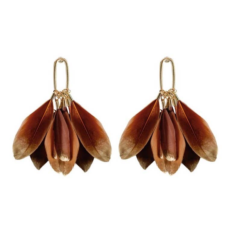 Caramel and gold-toned feather statement earrings displayed on a neutral background, highlighting texture and color