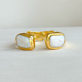 Gold open cuff bracelet featuring medium freshwater pearls on both ends.