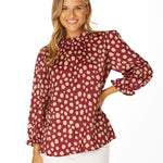 Garnet and gold animal print blouse with frill neckline, ruffle sleeves, and keyhole back closure