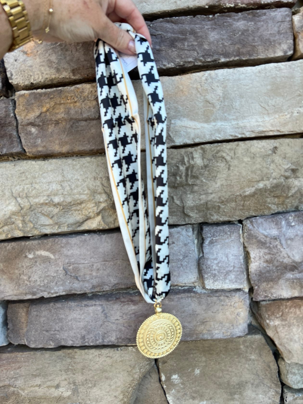 White and black houndstooth patterned scarf necklace with gold border and gold medallion pendant, handmade by Hart Designs.