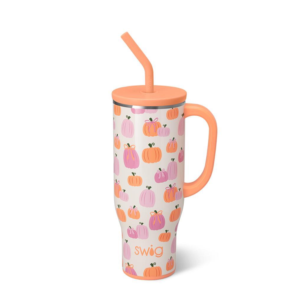 A 30oz insulated Mega Mug with a glitter ivory background, decorated with pink and orange pumpkins tied in bows, featuring a handle and straw.