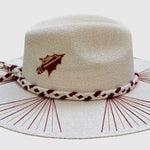 Ivory palm fedora with garnet and gold woven details, braided rope band, and embroidered spears on crown sides.