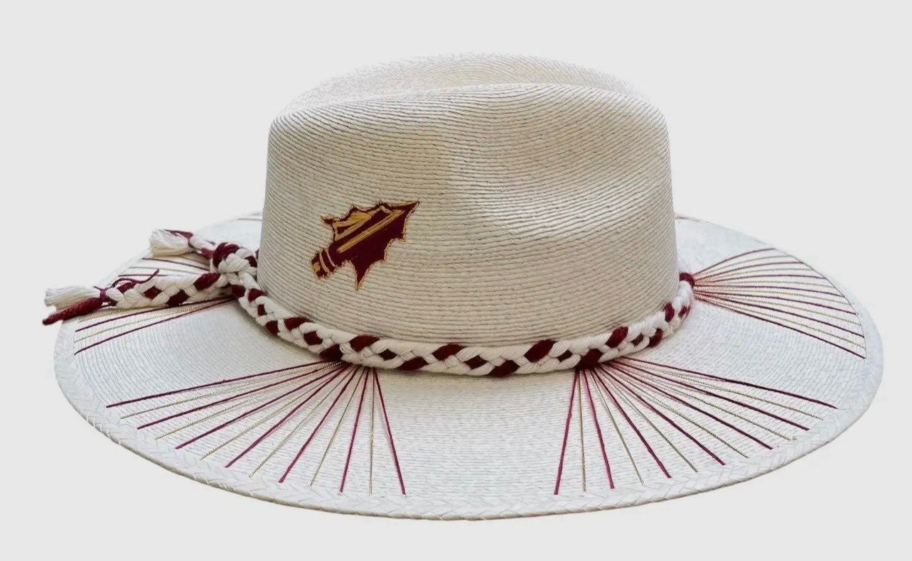 Ivory palm fedora with garnet and gold woven details, braided rope band, and embroidered spears on crown sides.