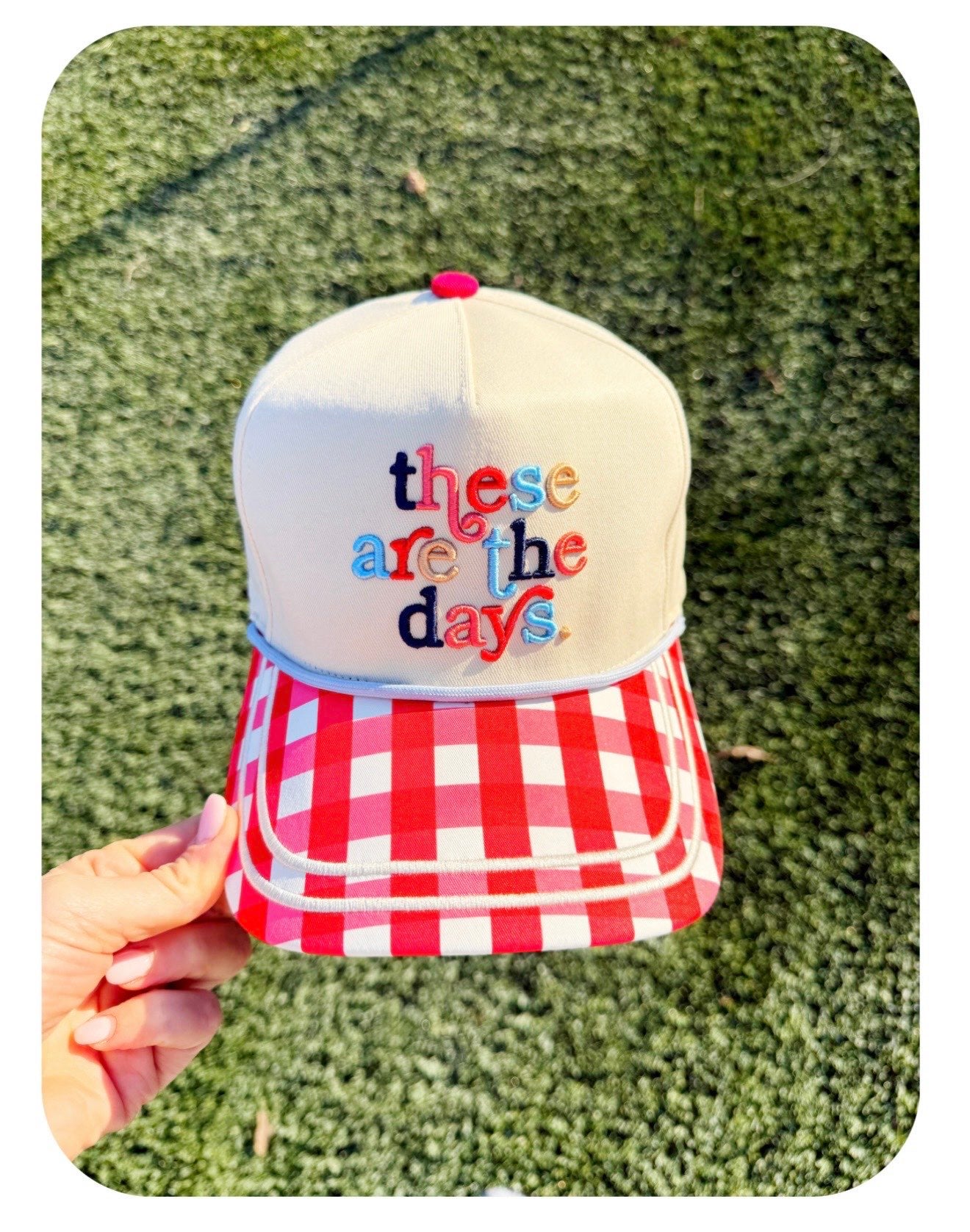 Cream snapback hat with red gingham brim and colorful embroidered designs