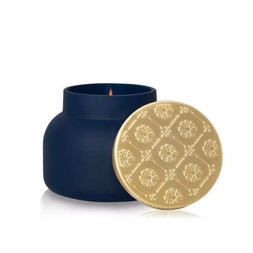 Matte midnight glass candle with sculpted brushed-gold architectural lid