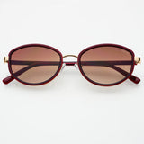 Burgundy oval sunglasses with biodegradable acetate frame, premium nylon lenses, and sleek lightweight design.