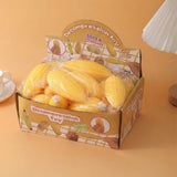 Yellow corn-shaped slow-rise stress relief squishy toy with a soft, rounded texture.