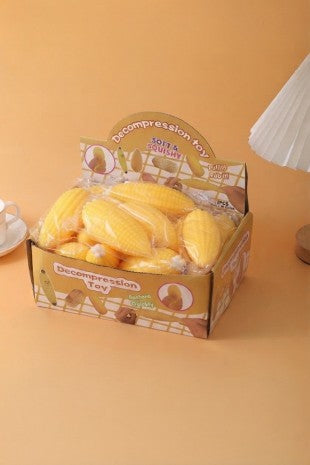 Yellow corn-shaped slow-rise stress relief squishy toy with a soft, rounded texture.