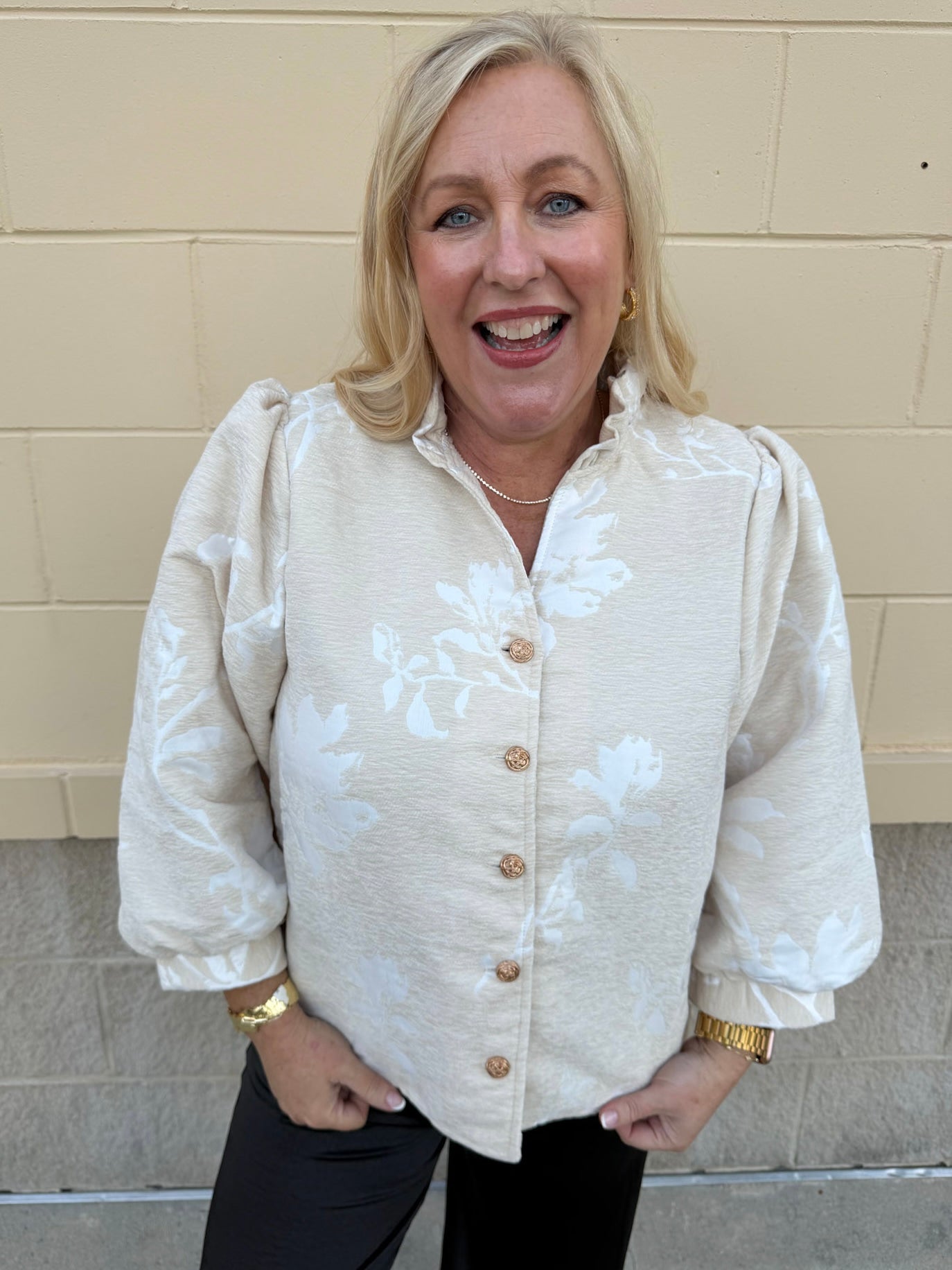 Oat velvet puff sleeve top with floral embroidery, gold buttons, and ruffle collar