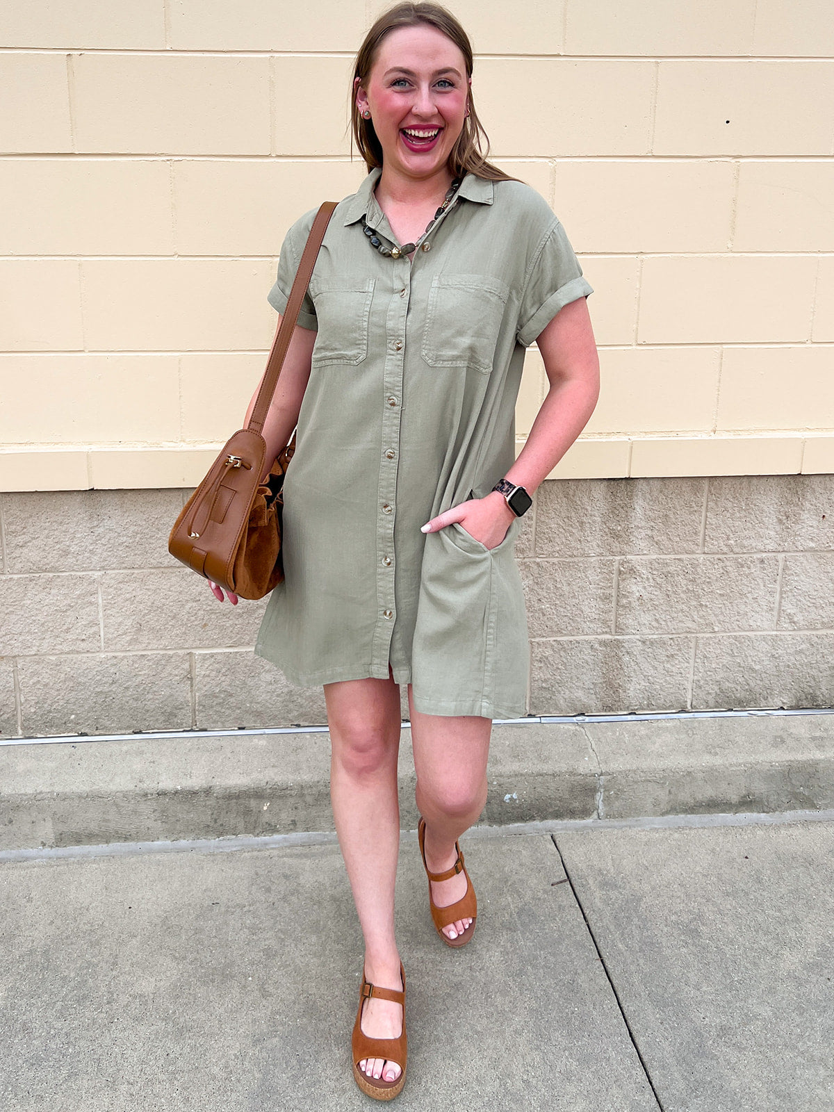 Sage green collared mini dress with short sleeves and front pockets.