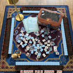 Osler x Hawthorne luxury mahjong tablescape with blue Osler tiles, Hawthorne mat, light blue shufflers, cognac tile storage bag, brass turtle dice catchall, Empress Blue dice and Golden Glow bamboo lamp