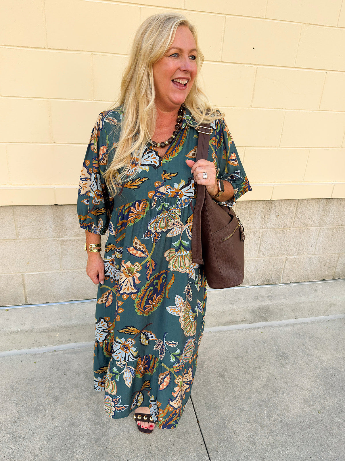 Teal collared midi dress with light orange, navy, and light blue floral-style print