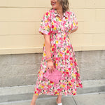 Floral cotton midi dress with pink and yellow flowers, drop shoulder sleeves, smocking, and pockets