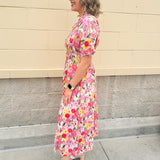 Floral cotton midi dress with pink and yellow flowers, drop shoulder sleeves, smocking, and pockets