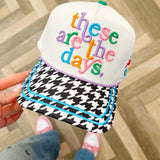 White embroidered canvas hat with houndstooth brim and colorful embroidered icons