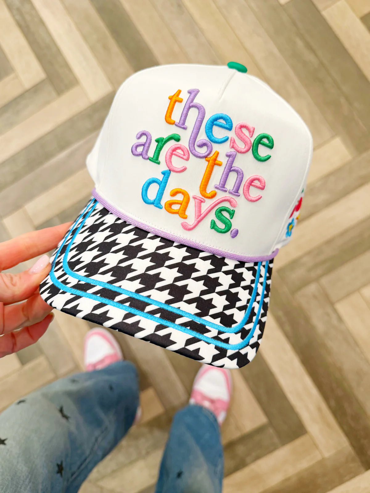 White embroidered canvas hat with houndstooth brim and colorful embroidered icons