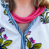 Berry-colored multi-strand cotton rope necklace with a ball-and-eye closure displayed as a bold, seasonal accessory