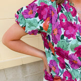 Vibrant raspberry floral blouse with ruffle-trimmed split neckline and short puff sleeves