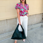 Vibrant raspberry floral blouse with ruffle-trimmed split neckline and short puff sleeves